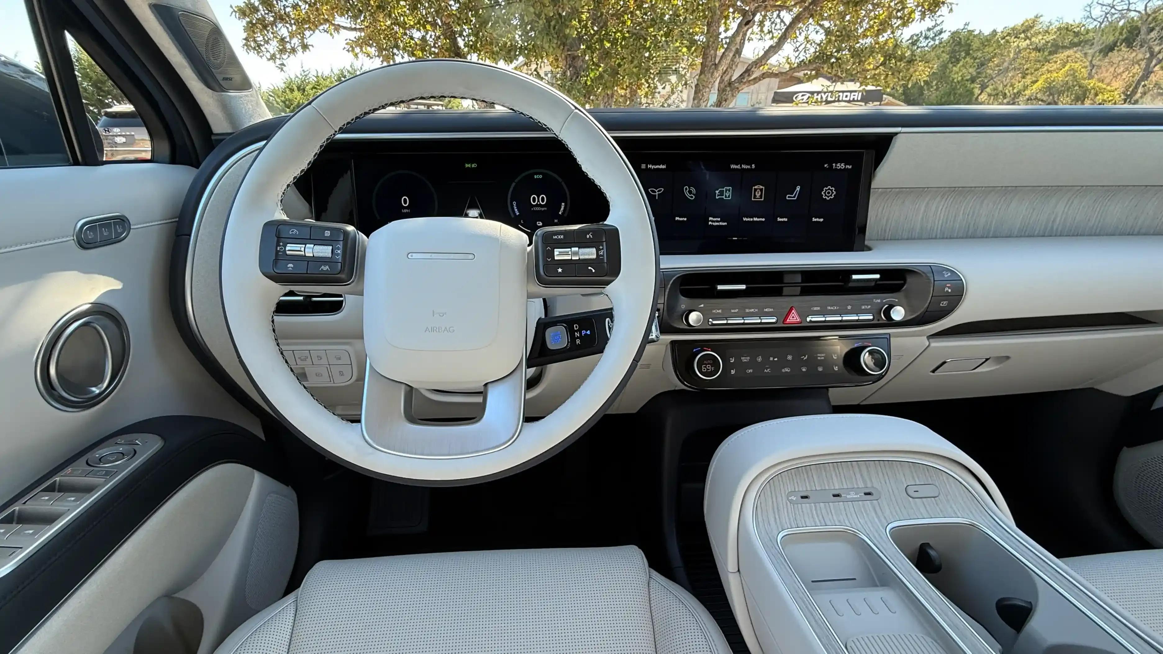 Hyundai Palisade dashboard and front seats with a digital instrument cluster and wide center screen.