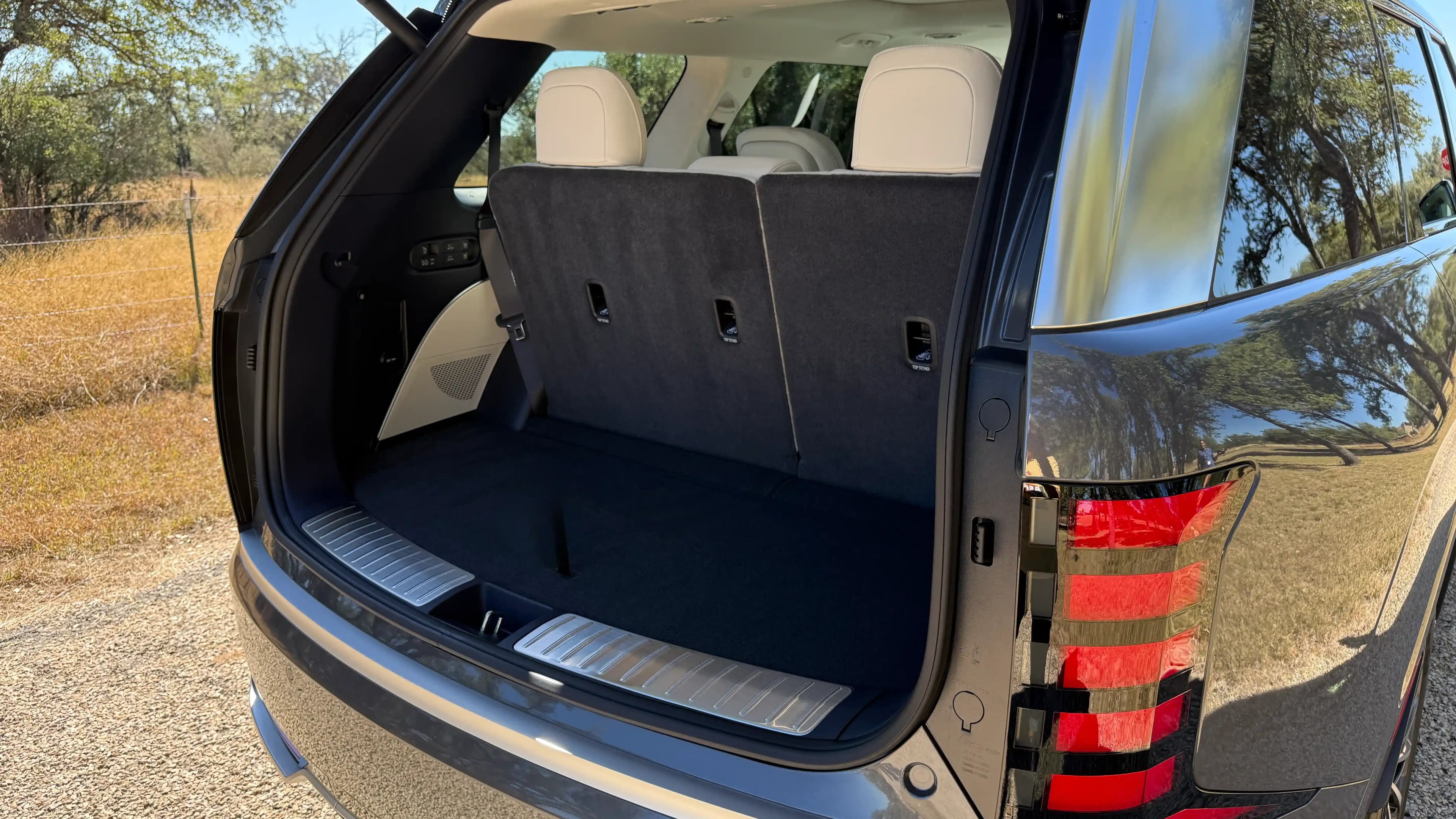 Rear cargo area of a Kia Telluride Hybrid with the third row folded up.
